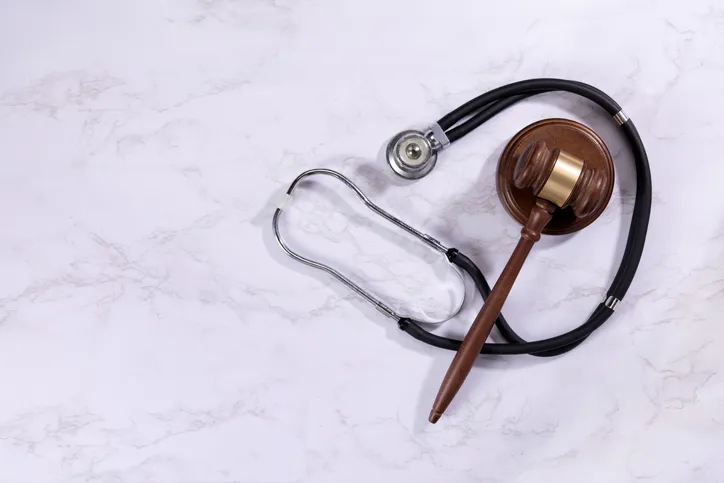 a stethoscope and a gavel on a marble background